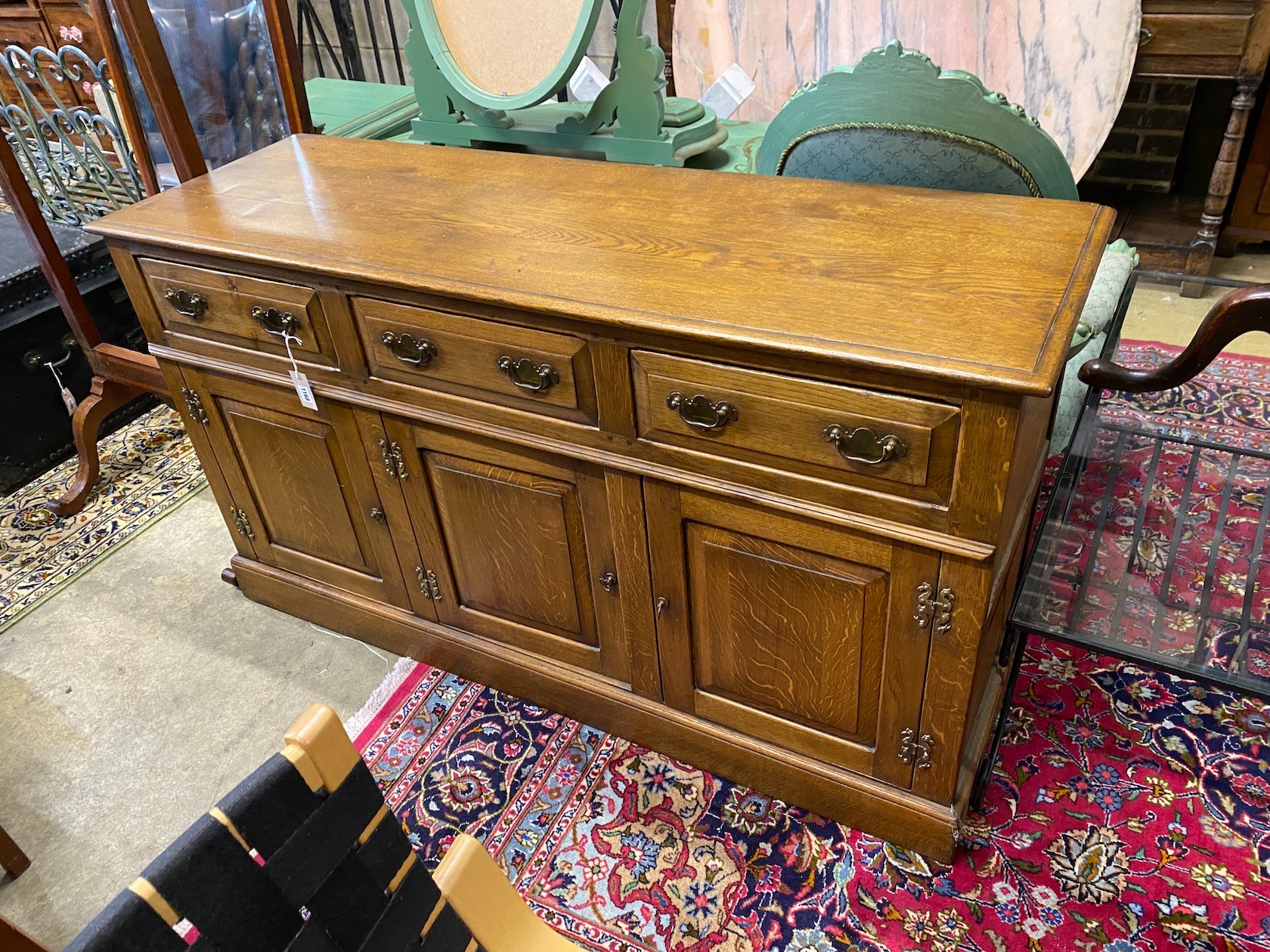 A reproduction 18th century style oak low dresser, fitted three drawers over three cupboards, length 152cm, width 50cm, height 85cm